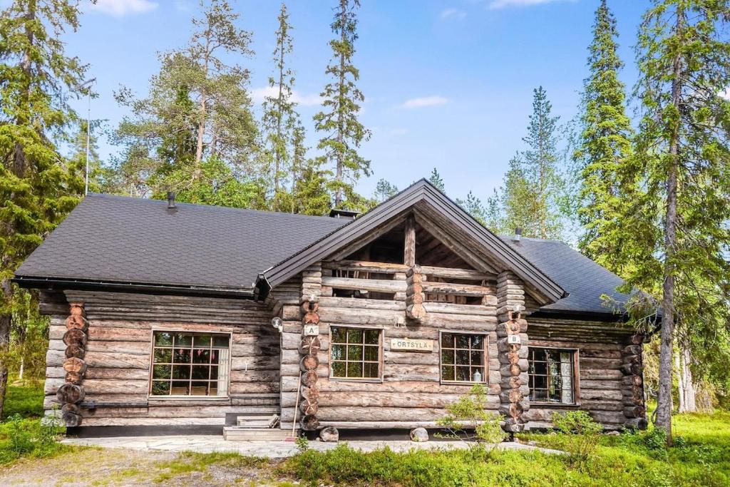 a log cabin in the woods with trees at Vacation home 'Örtsylä A' in Salla