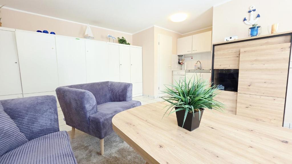 a living room with a wooden table and two chairs at Stettiner Str 6b in Grömitz