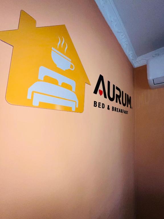 a sign for a bed and breakfast on a wall at Aurum Stays in Gaborone