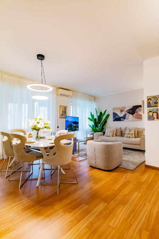 a dining room and living room with a table and chairs at Como Prestige Centro Apartment By Icon7 Luxury in Como