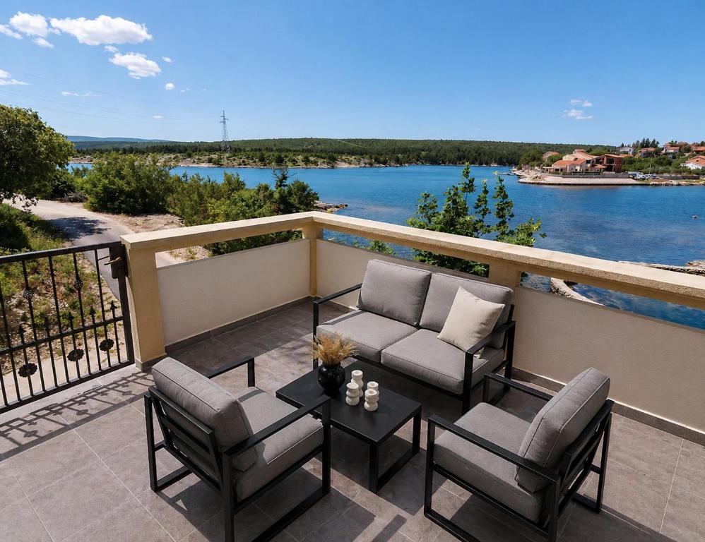 a patio with two chairs and a table on a balcony at Apartman Ivana in Kruševo