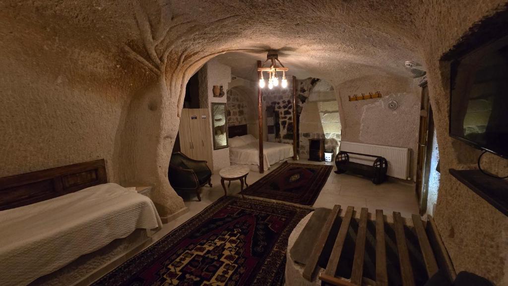 a room with a bed and a couch in a cave at Uchisar Cave House in Uçhisar