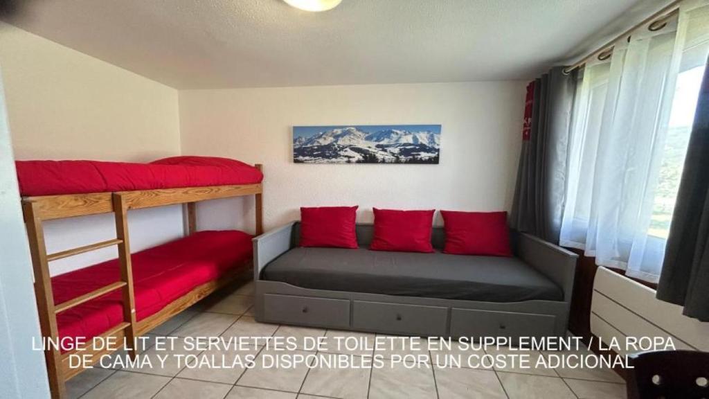 a bedroom with two bunk beds and red pillows at APPARTEMENT BICHE in La Llagonne