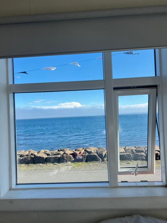 a window with a view of the ocean at Summerhouse by the ocean in Drangsnes