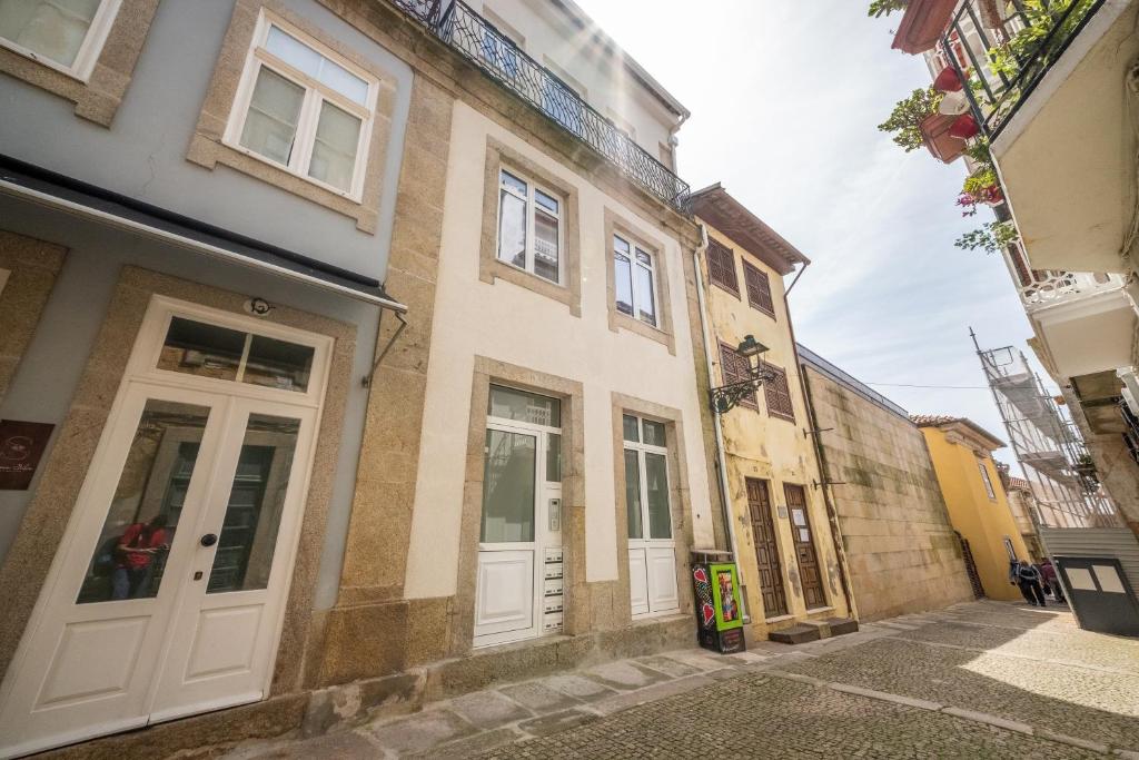 a building with white doors on a street at Barcelos Center in Barcelos