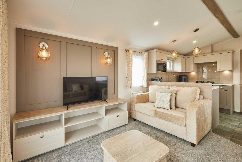 a living room with a television and a couch at Host & Stay - Stag Lodge in Pickering