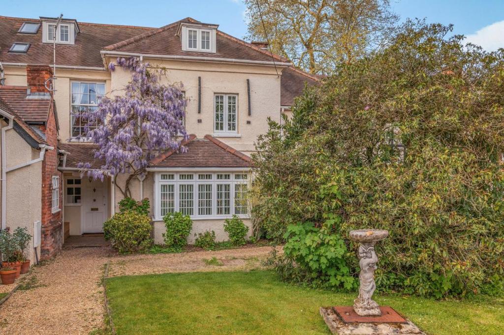 a house with a flowering tree in the yard at 4 Bed in Lyndhurst oc-nfl57 in Lyndhurst