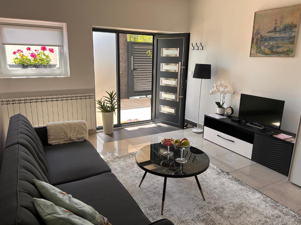 a living room with a couch and a table at Apartman 4N with free parking in Belgrade