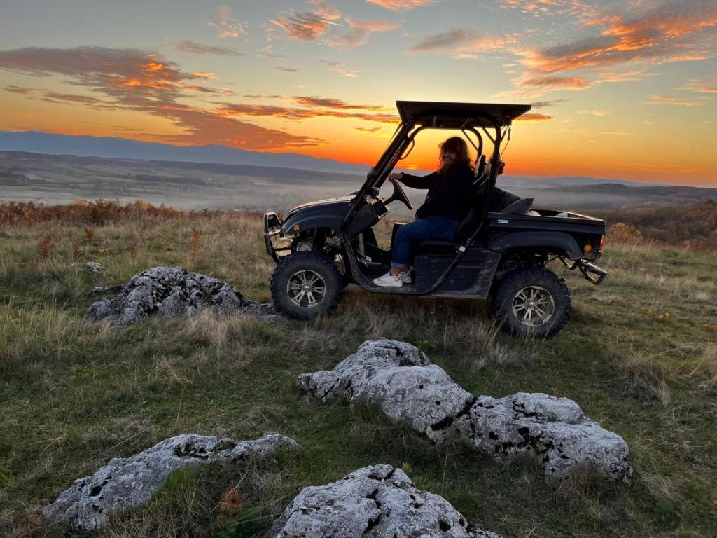 a person sitting in a golf cart on a hill at Meziad-Panorama in Meziad