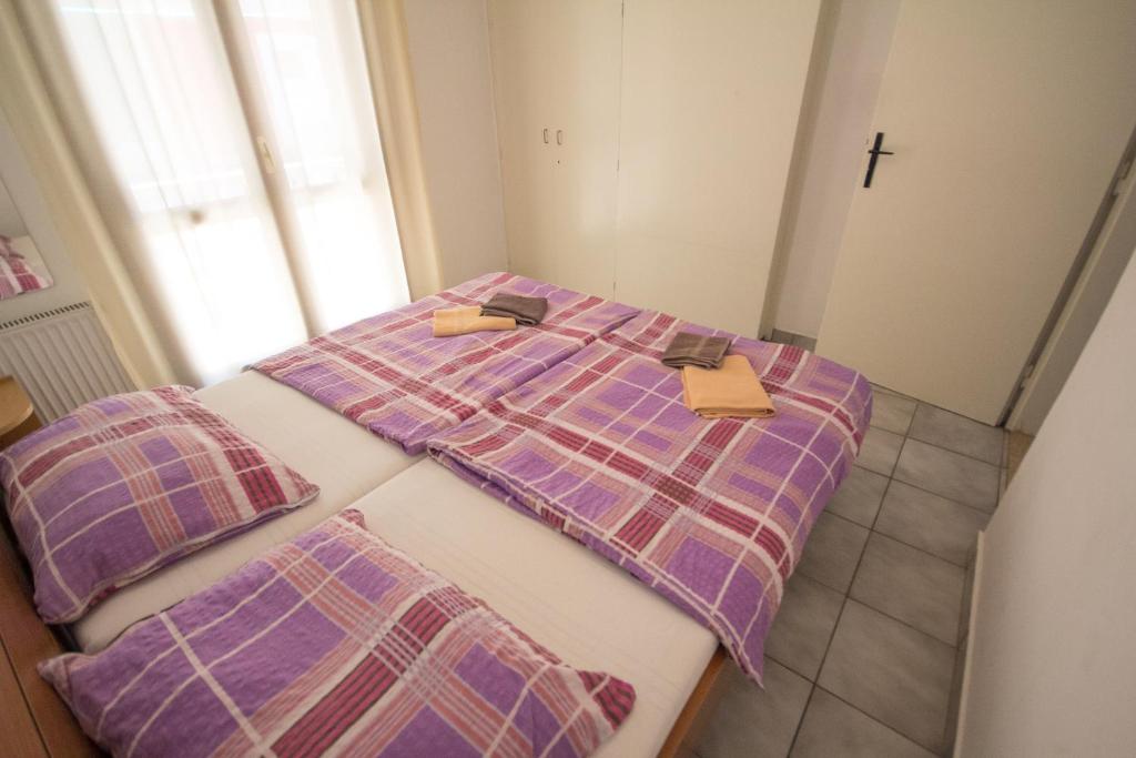 a bed with two pillows on top of it at Private Apartments Stella Maris in Umag