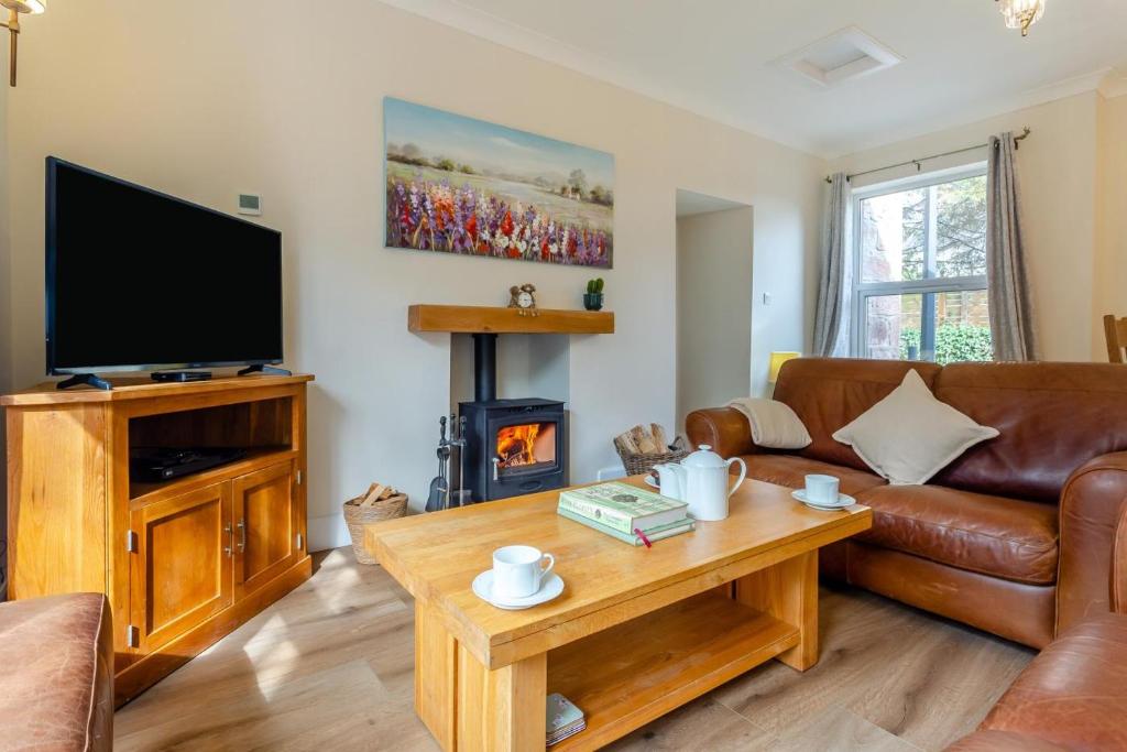 a living room with a couch and a television at 3 Bed in Dingwall oc-m39032 in Dingwall