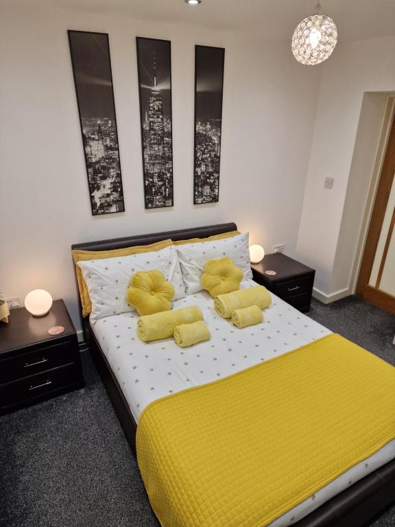 a bedroom with a yellow bed with two yellow pillows at Cosynite B&B for 2 in Birmingham