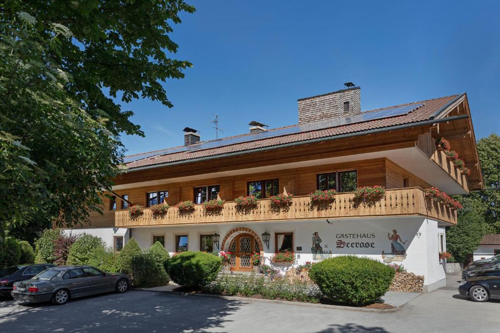 a building with a balcony on top of it at Hotel Seerose in Rottach-Egern