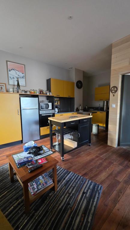 a living room with a table and a kitchen at T1 duplex centre Argeles Gazost in Argelès-Gazost