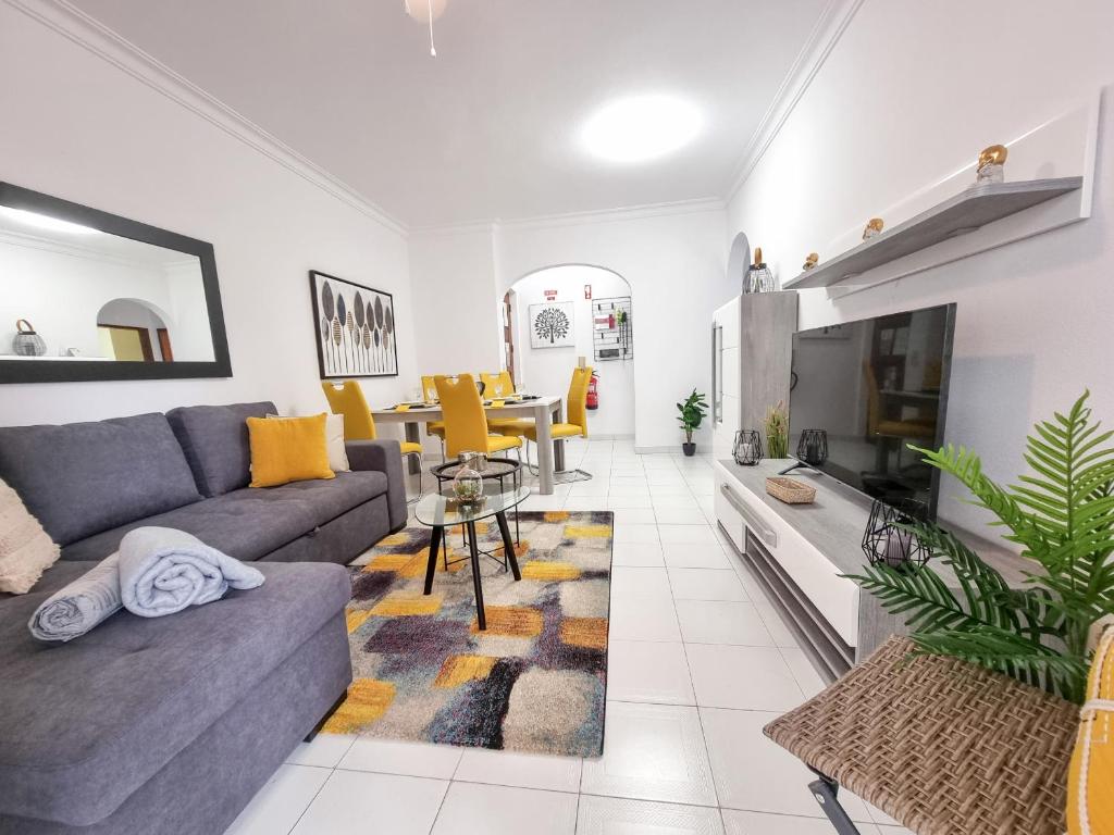 a living room with a couch and a table at Apartment Praia Rocha Candimar Sunflower in Portimão