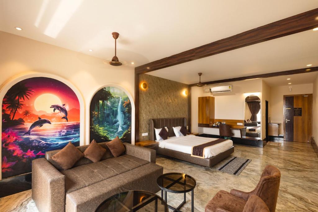 a bedroom with a couch and a bed in a room at Nautical 9 Beach Retreat in Kundapur