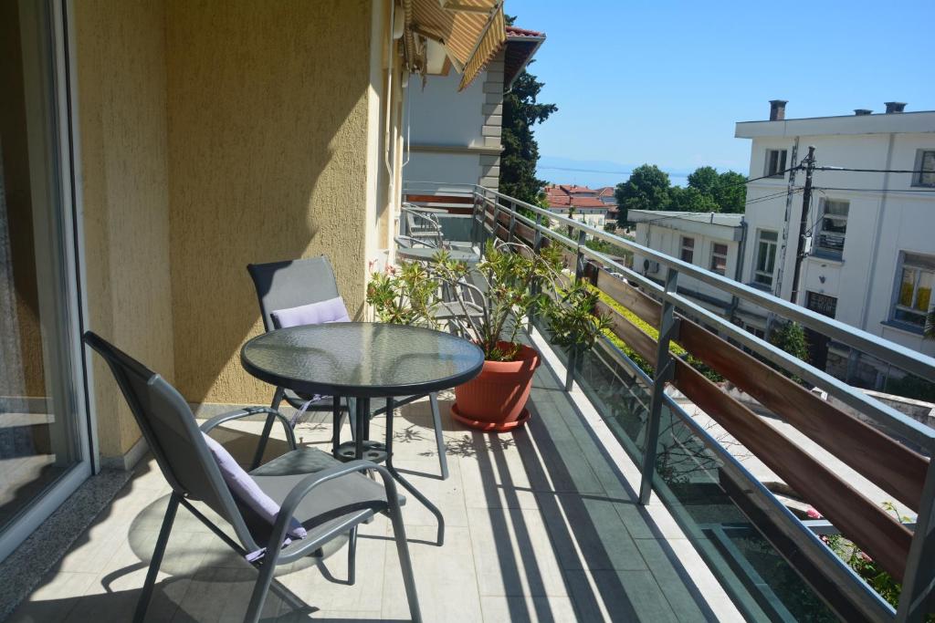 a balcony with a table and chairs on a balcony at Apartments Orange Lovran in Lovran
