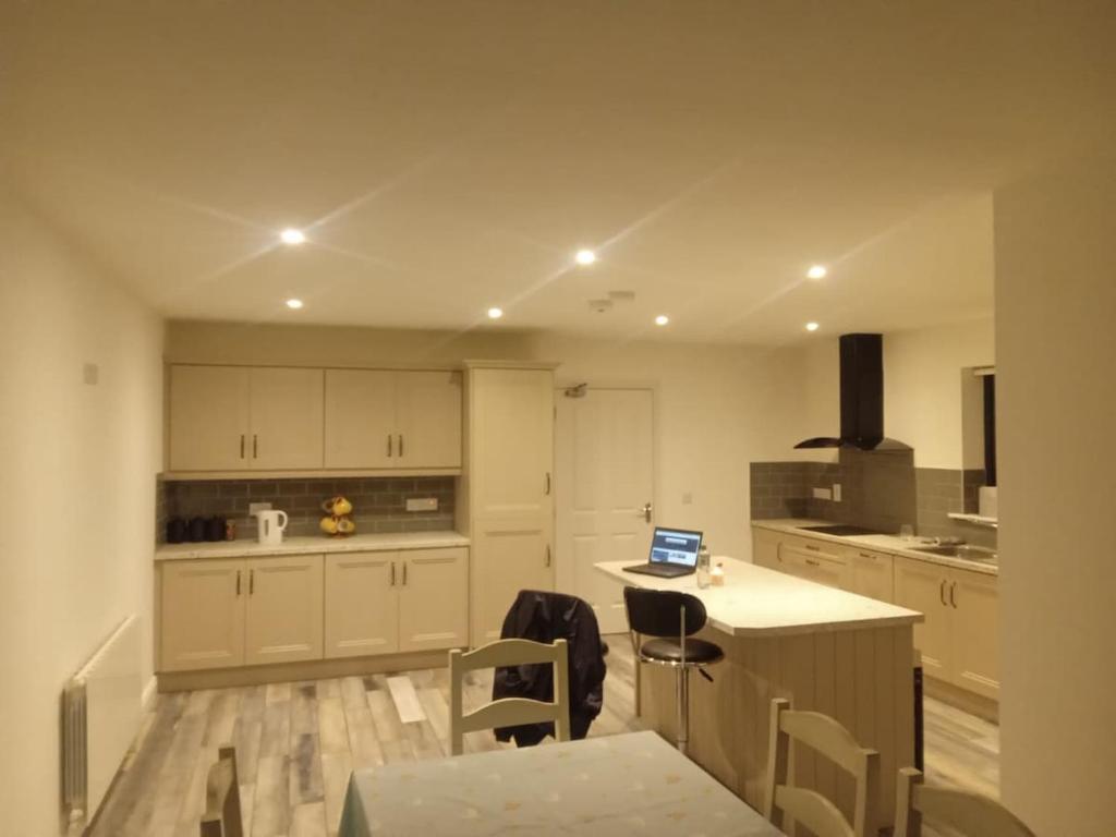a kitchen with a table with a laptop on it at Parochial View in Athboy