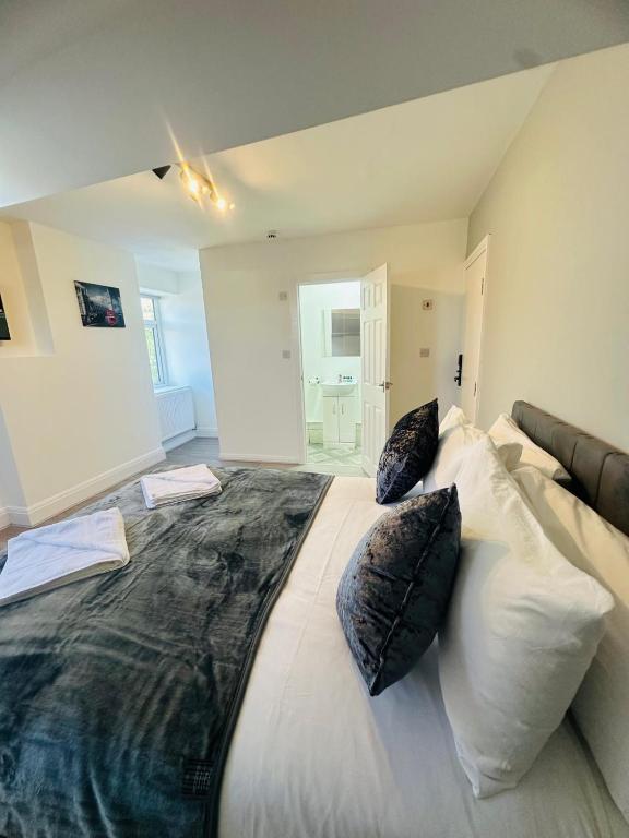 a bedroom with a large bed with pillows on it at Melrose Abbey Guest House in Liverpool
