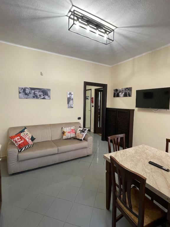 a living room with a couch and a table at maison du cinemà in Turin