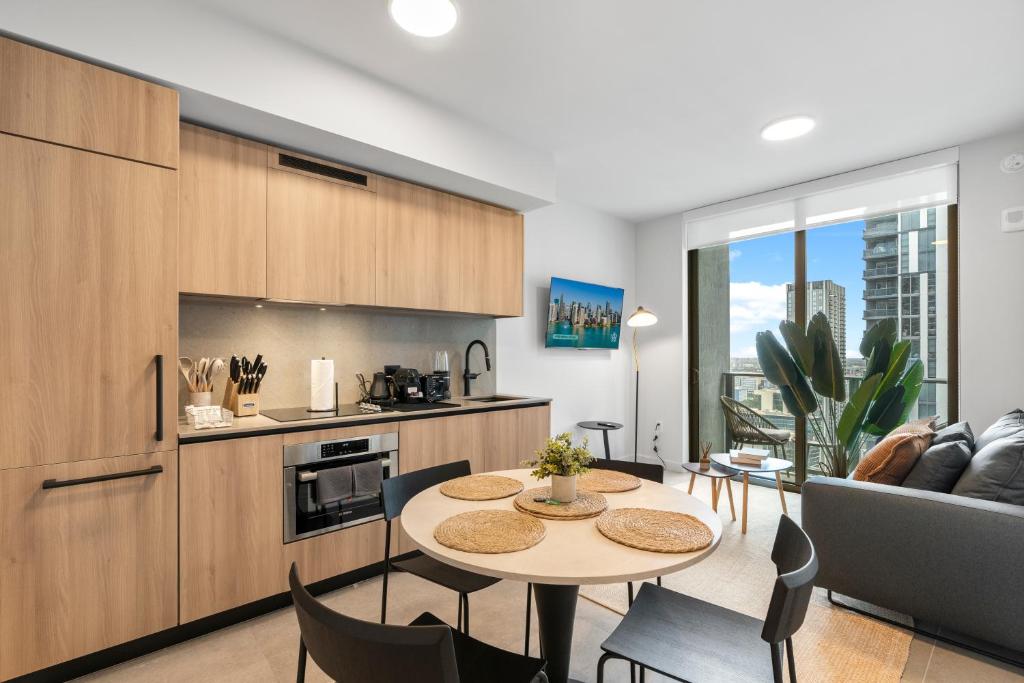 a kitchen and living room with a table and chairs at Prime Downtown Condo with City Views in Miami