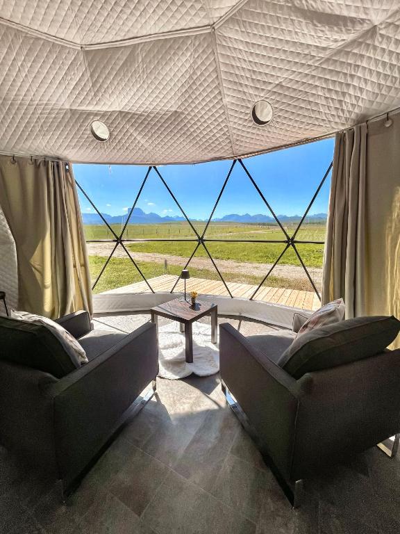 a living room with two couches and a table at Chief Mountain Cabins in Carway