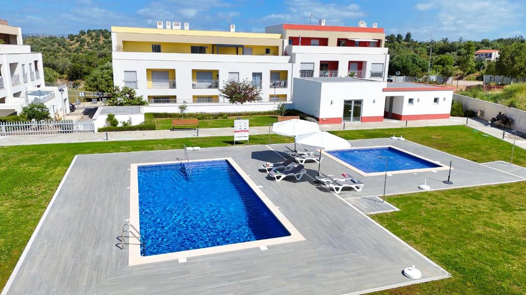 an overhead view of a swimming pool in front of a building at Tavira Escape with Pool by BeCherish in Tavira