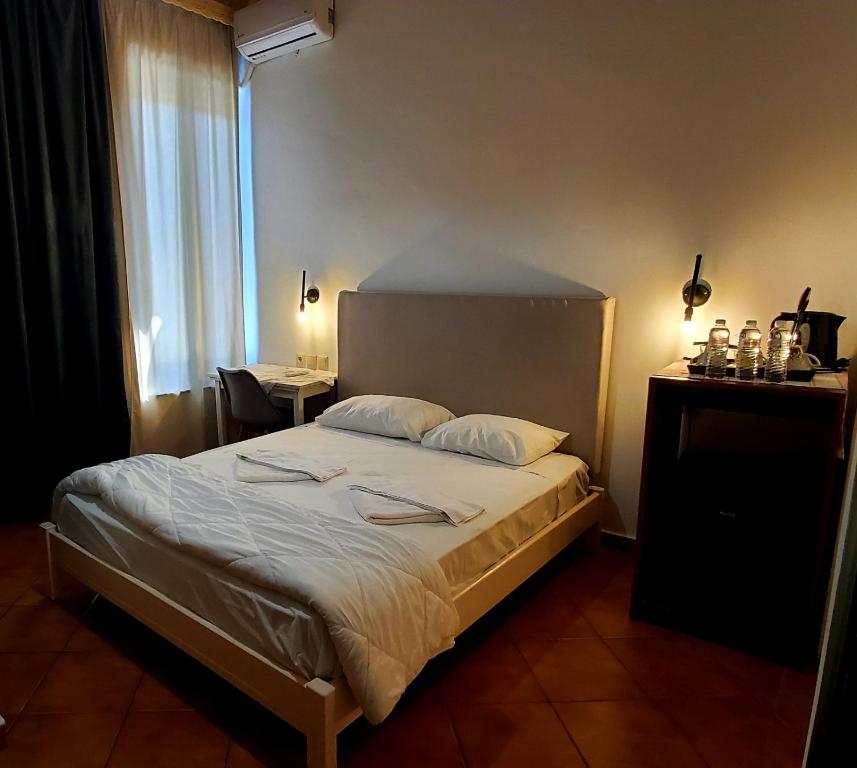a bedroom with a bed and a large window at Diporto in Chania
