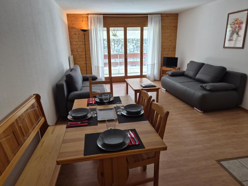 a living room with a table and a couch at Torgon in Torgon