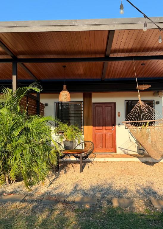 a porch with a swing and a house at Apartamento 2, cerca de la playa, naturaleza y paz in Santa Cruz