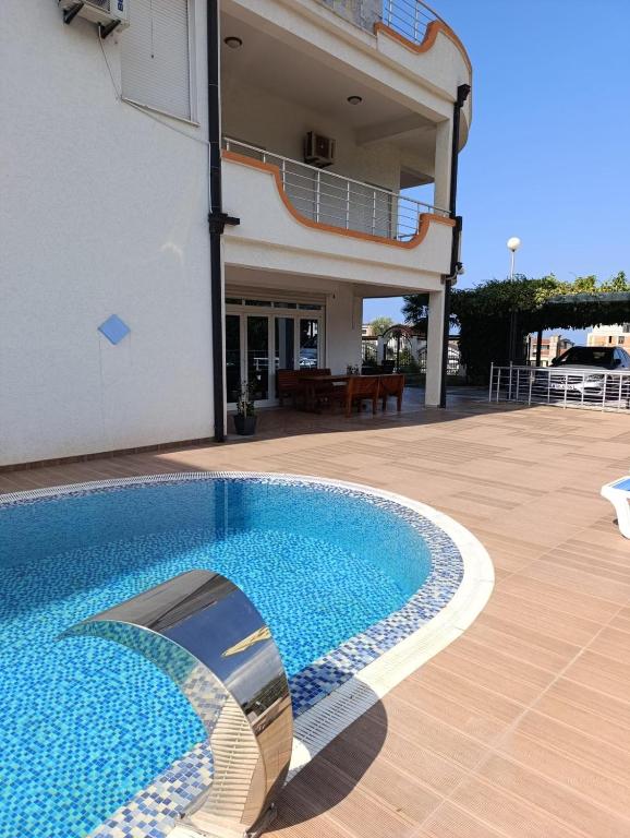 a swimming pool in front of a building at Vila Pepic in Dobra Voda
