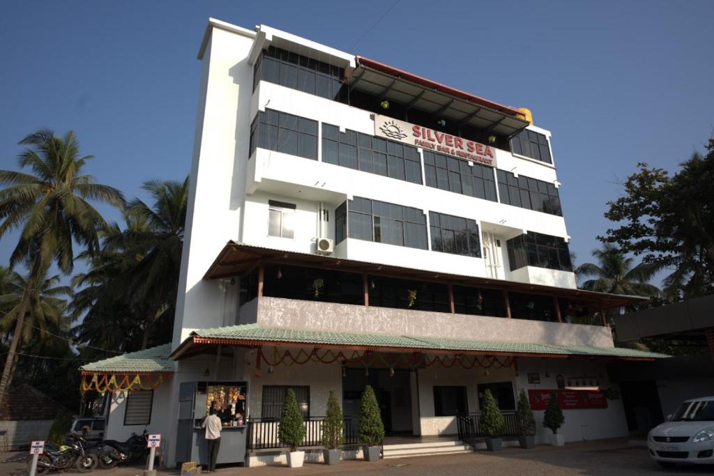 a white building with a sign on it at Silver Sea in Patna
