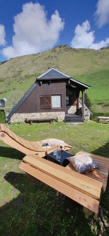 a wooden table in front of a building at La Bergerie d'Espiaube in Saint-Lary-Soulan