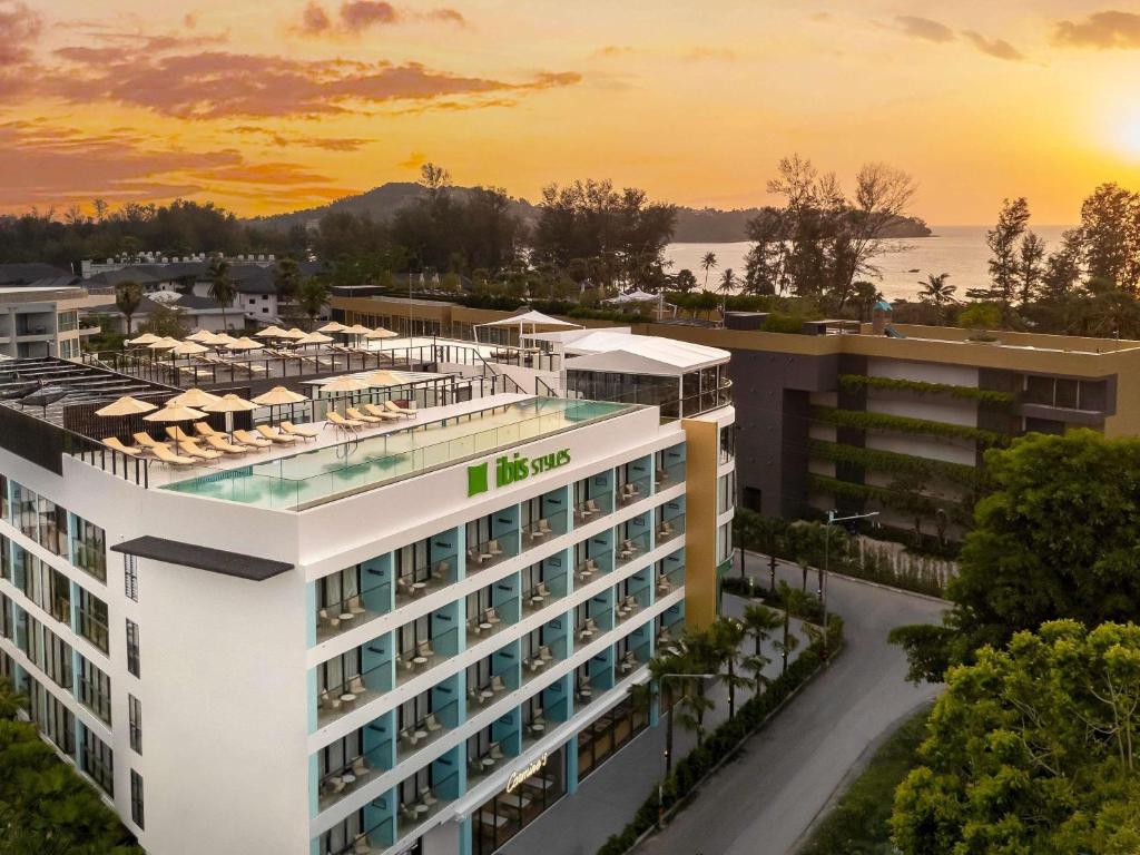 an aerial view of a hotel with the sunset in the background at ibis Styles Phuket Bangtao in Bang Tao Beach