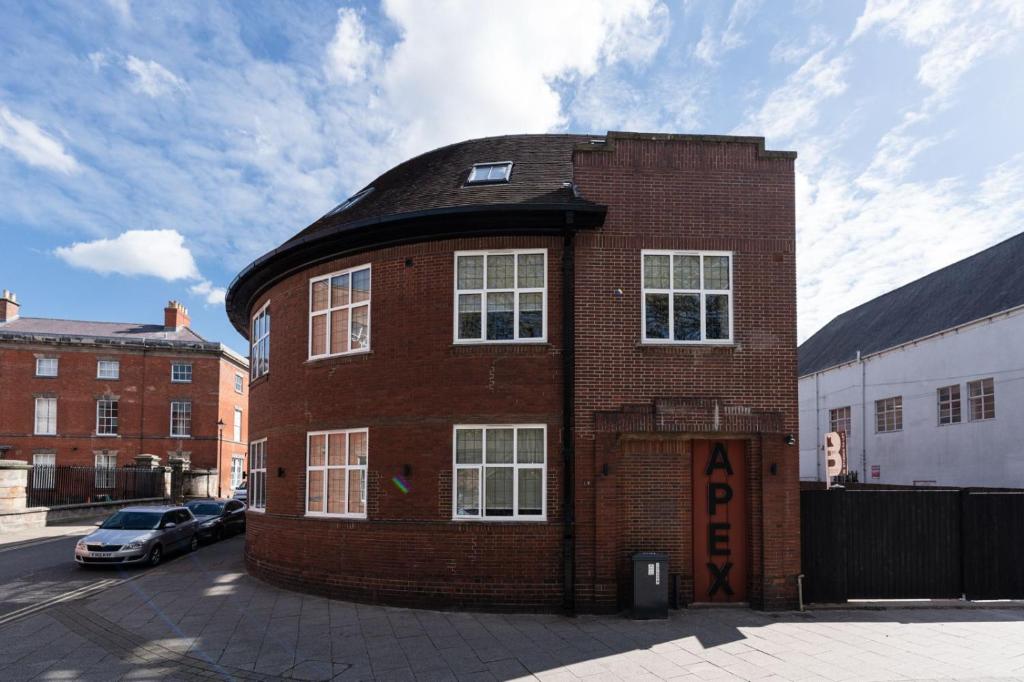 a red brick building with a black roof at Apex Studios by Derbnb in Derby