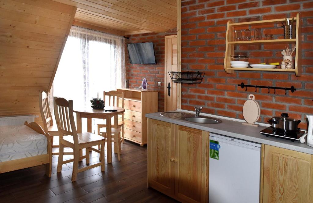 a kitchen with a sink and a counter top at Agroturystyka Rumcajsówka in Bałtów
