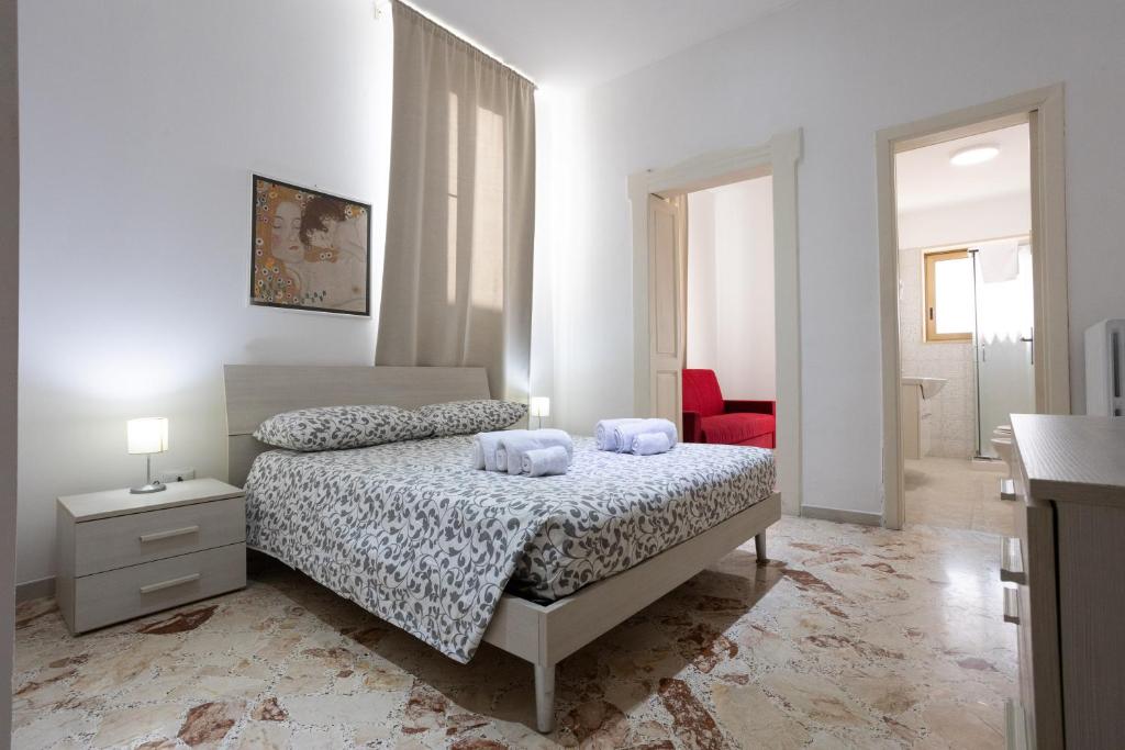 a bedroom with a bed with two towels on it at A Casa di Paola B&B Lecce in Lecce