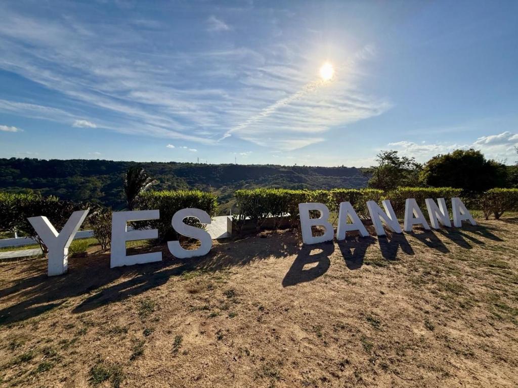 a sign that says vasbanan in a field at yes banana in Bananeiras