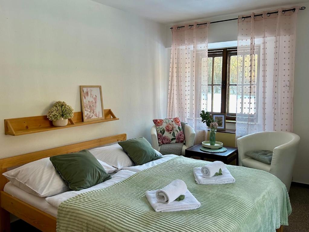 a bedroom with a bed with towels on it at Rezidence - HAMR in Nové Hrady