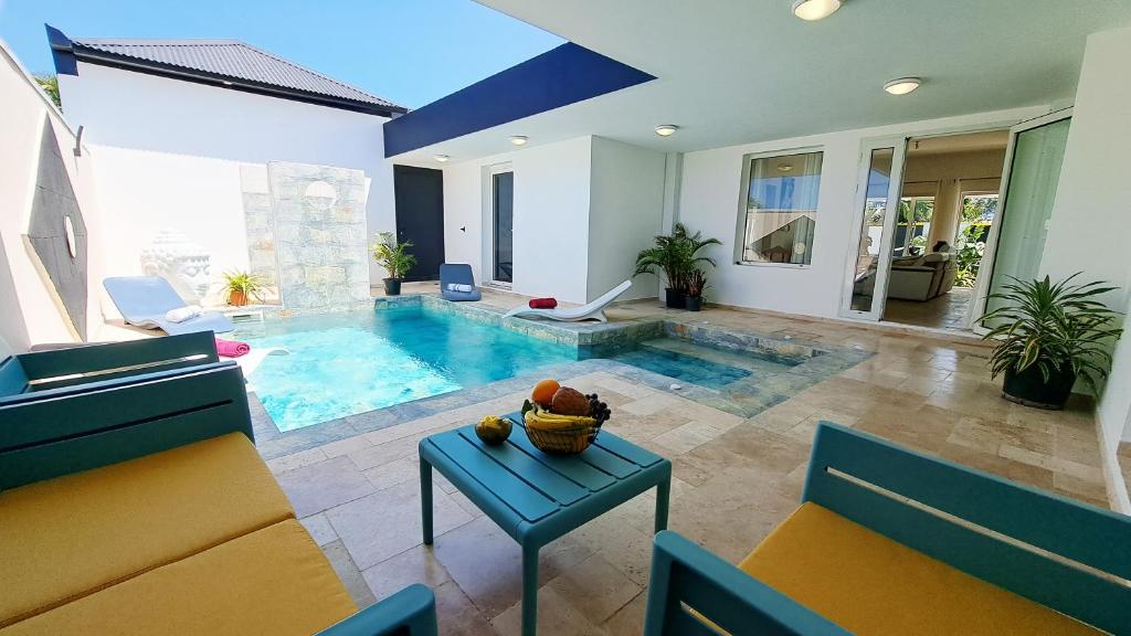 a living room with a swimming pool in a house at Azot Villa in Le Tampon