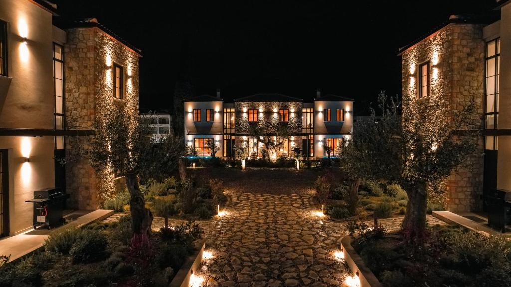 an exterior view of a building at night at Képos Villas Sivota in Syvota