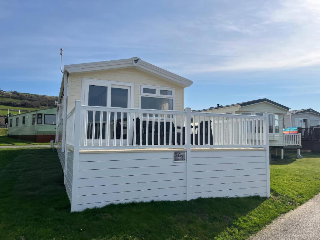a small house with a white fence at 26 Ocean View in Llwyngwril