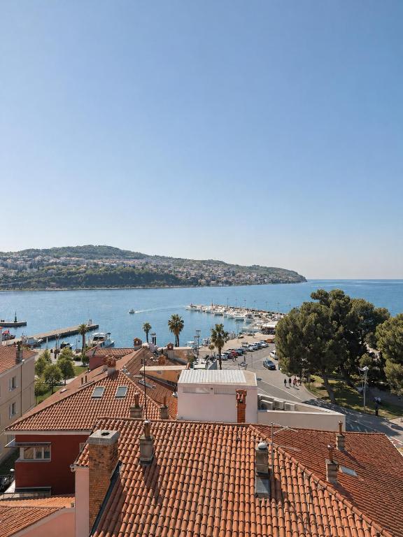 a view of a town with a harbor and the water at NAIA apartment in Koper