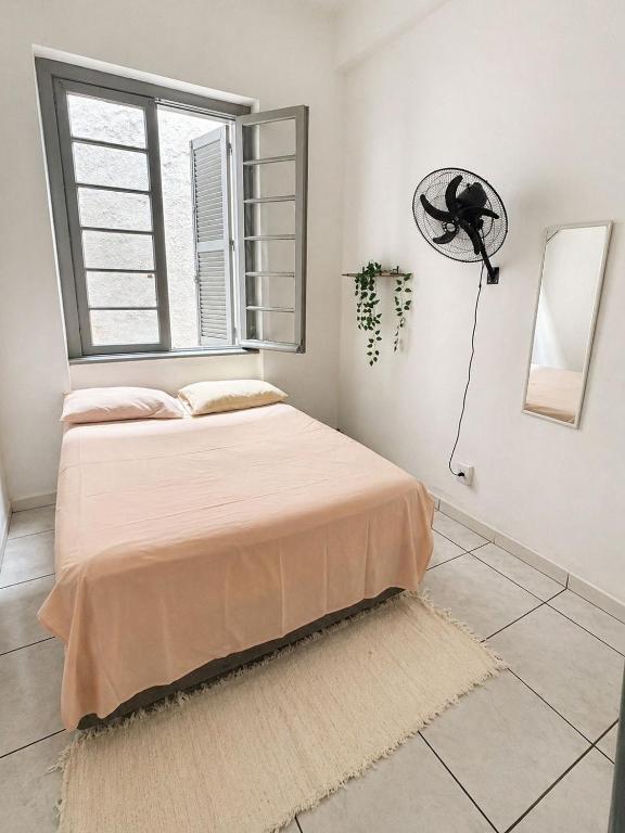 a bedroom with a bed and a window at Hostel & Coffe Bahia in Porto Alegre