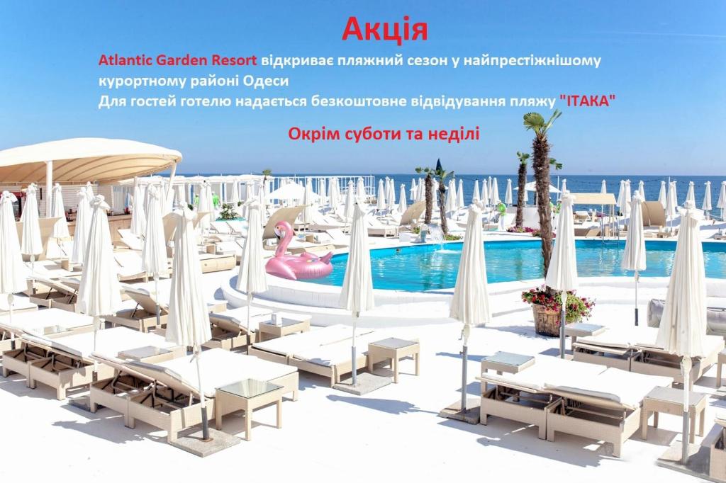 a resort with a pool and a pink flamingo at Atlantic Garden Resort in Odesa