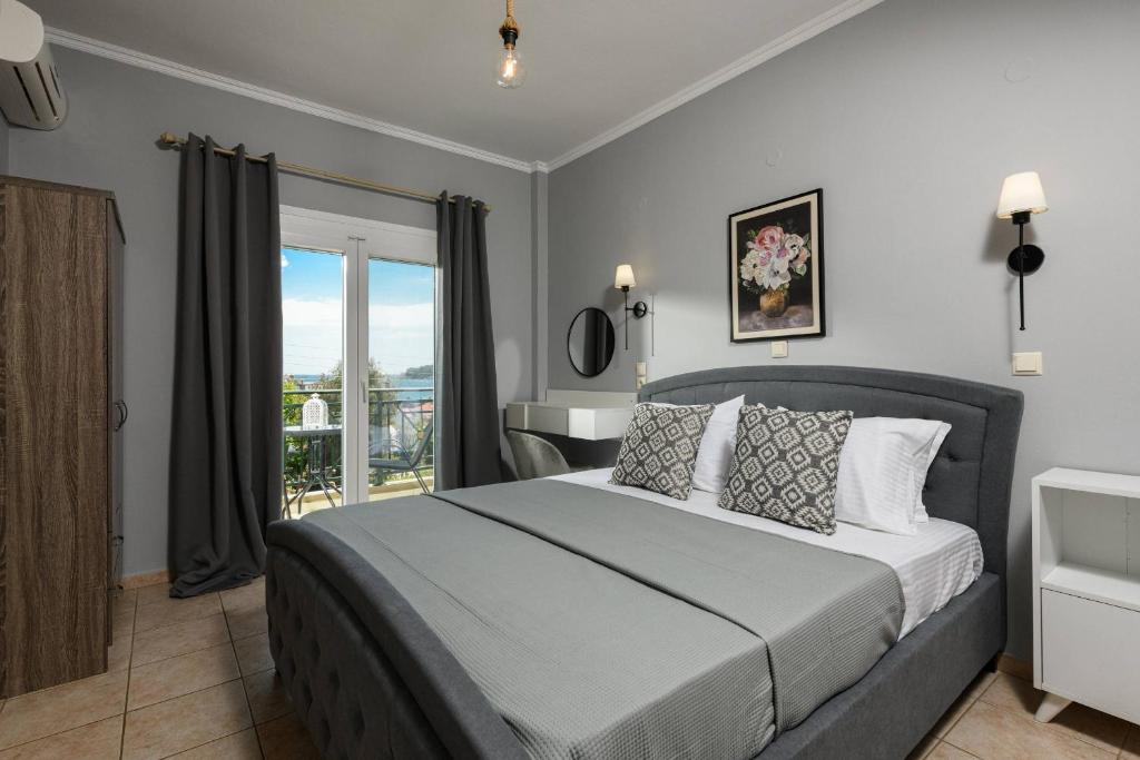 a bedroom with a large bed and a balcony at Dimitreli Venetia Studios in Koinyra