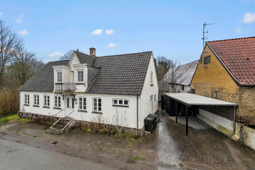 a white house with a black roof at 20229-Samso-Byvejen-20 in Hårdmark