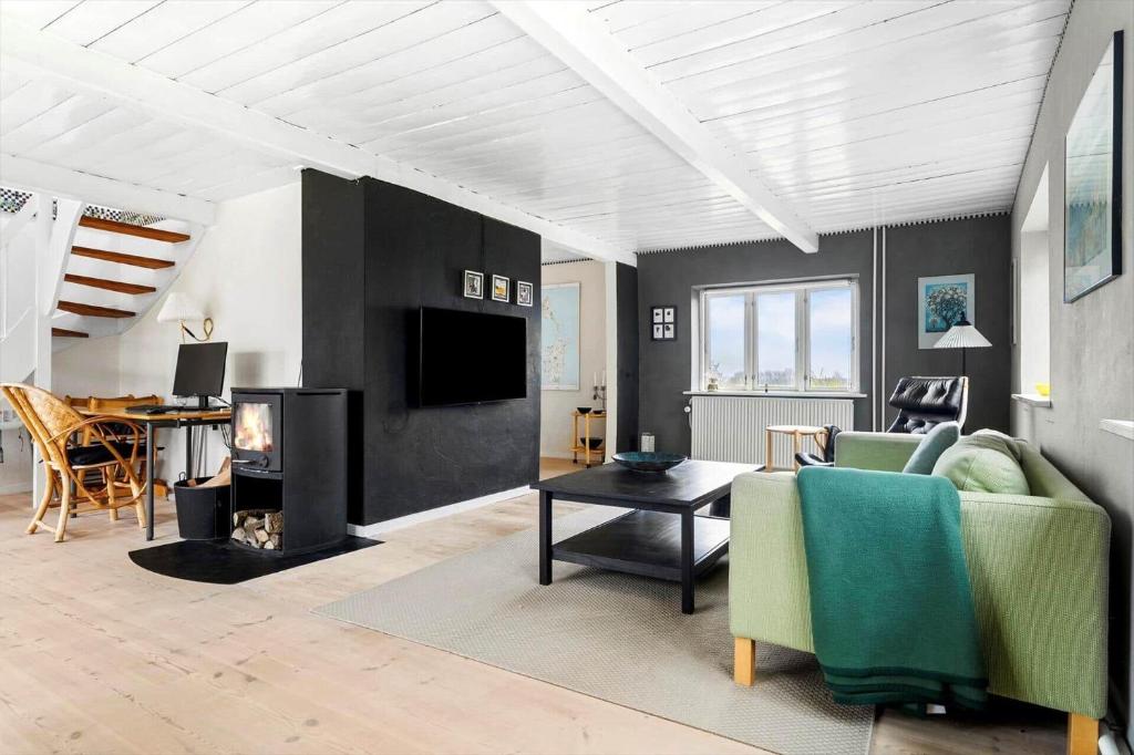 a living room with a couch and a fireplace at 20622-Samso-Skolebakkevej-38 in Brundby