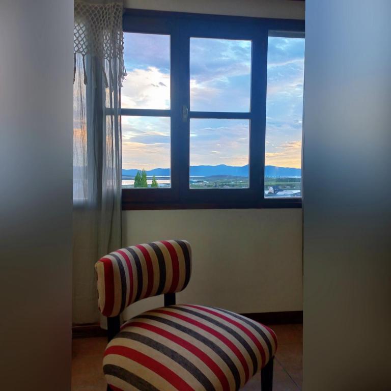 a chair sitting in front of a window at Mountain, espectacular departamento con vista súper funcional in Ushuaia