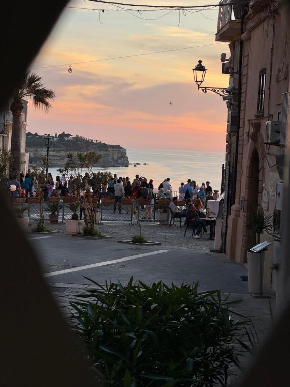 a group of people on the beach at sunset at Mare Fuori Apartment in Tropea